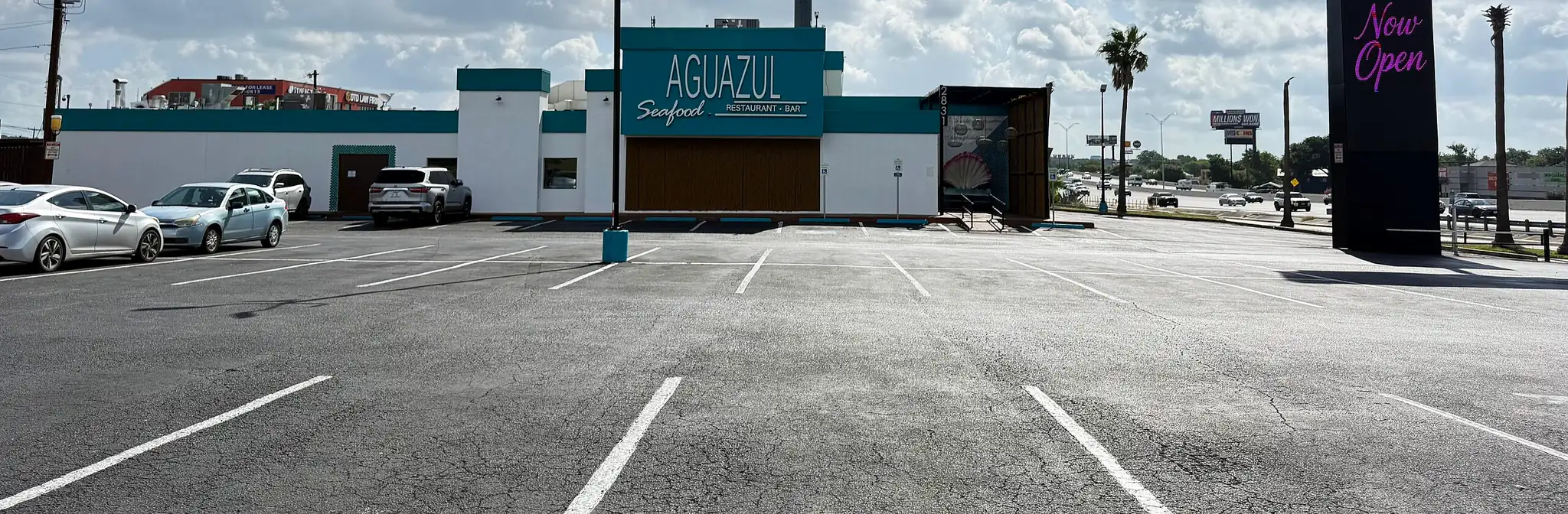 The teal Aguazul building under a bright Texas sky