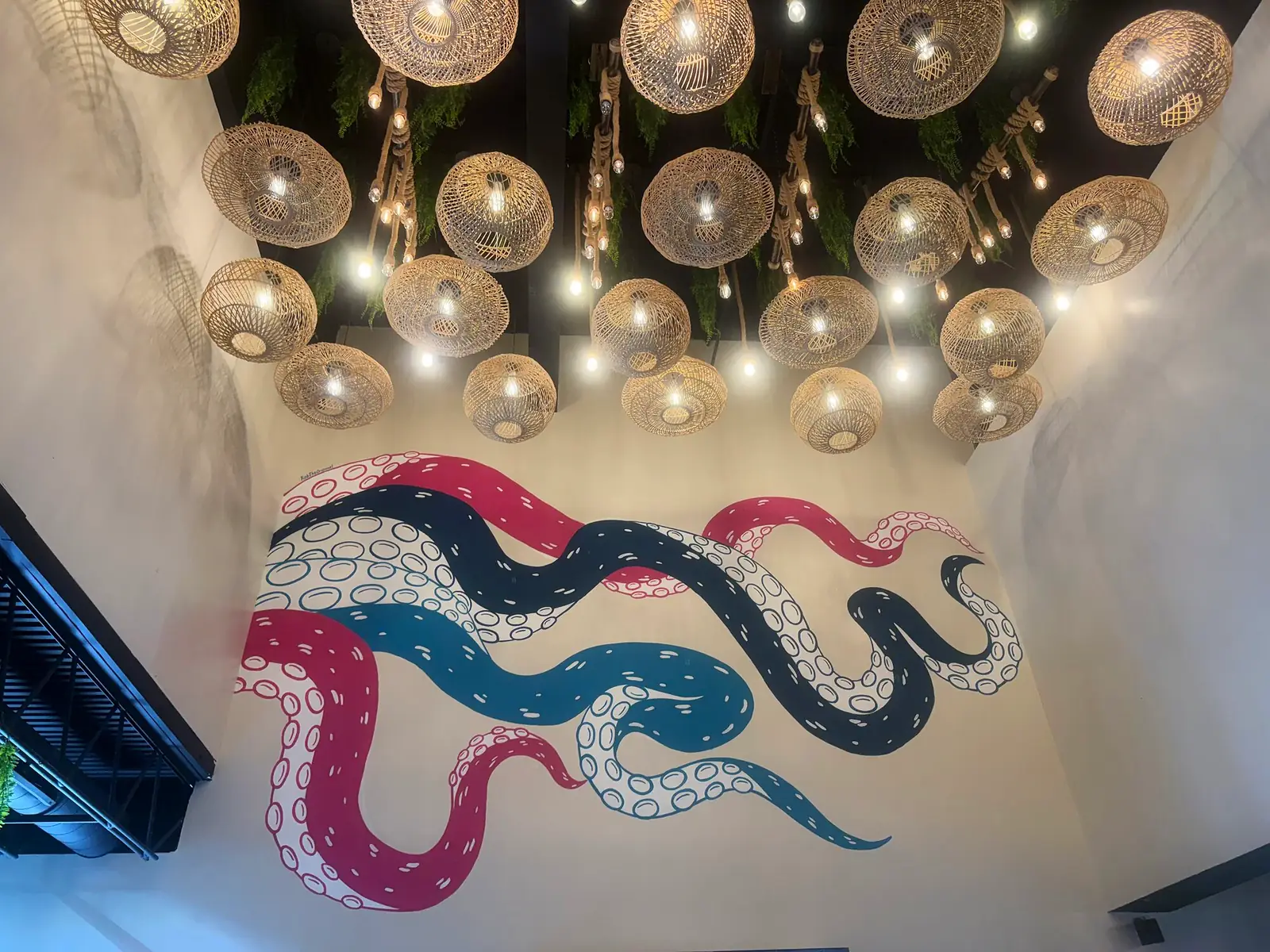 Rattan lanterns and the tentacle mural above the dining room